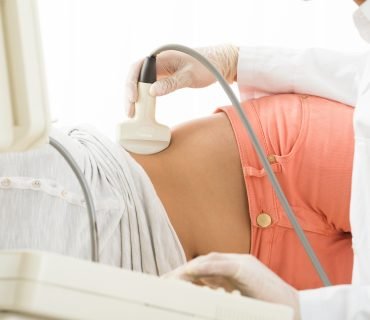 Doctor Is Using Ultrasound Machine To Scan Women's Abdomen In The Clinic